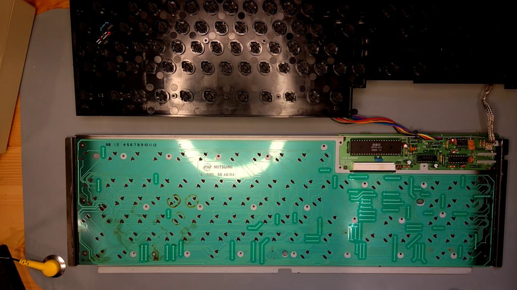 Amiga 500 keyboard with the keys and plastic base removed, showing the flexible membrane with some stains
