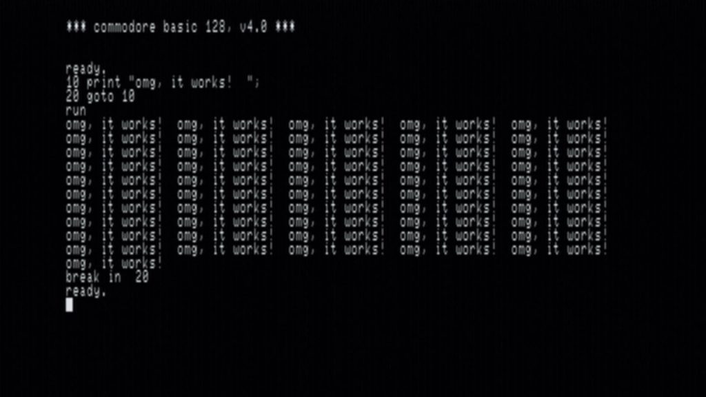 Screen shot from a functional Commodore B128, with the opening 'commodore basic 128, v4.0' boot message, and a BASIC program that repeatedly outputs 'omg, it works!'