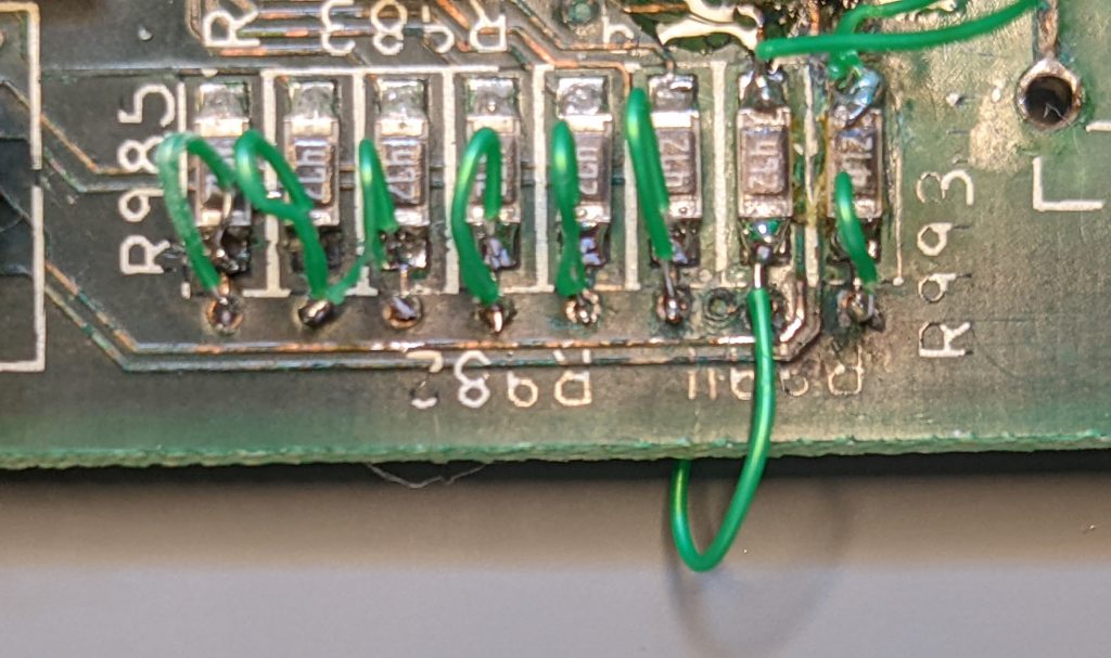 Eight SMD resistors with their inputs connected to the vias below them