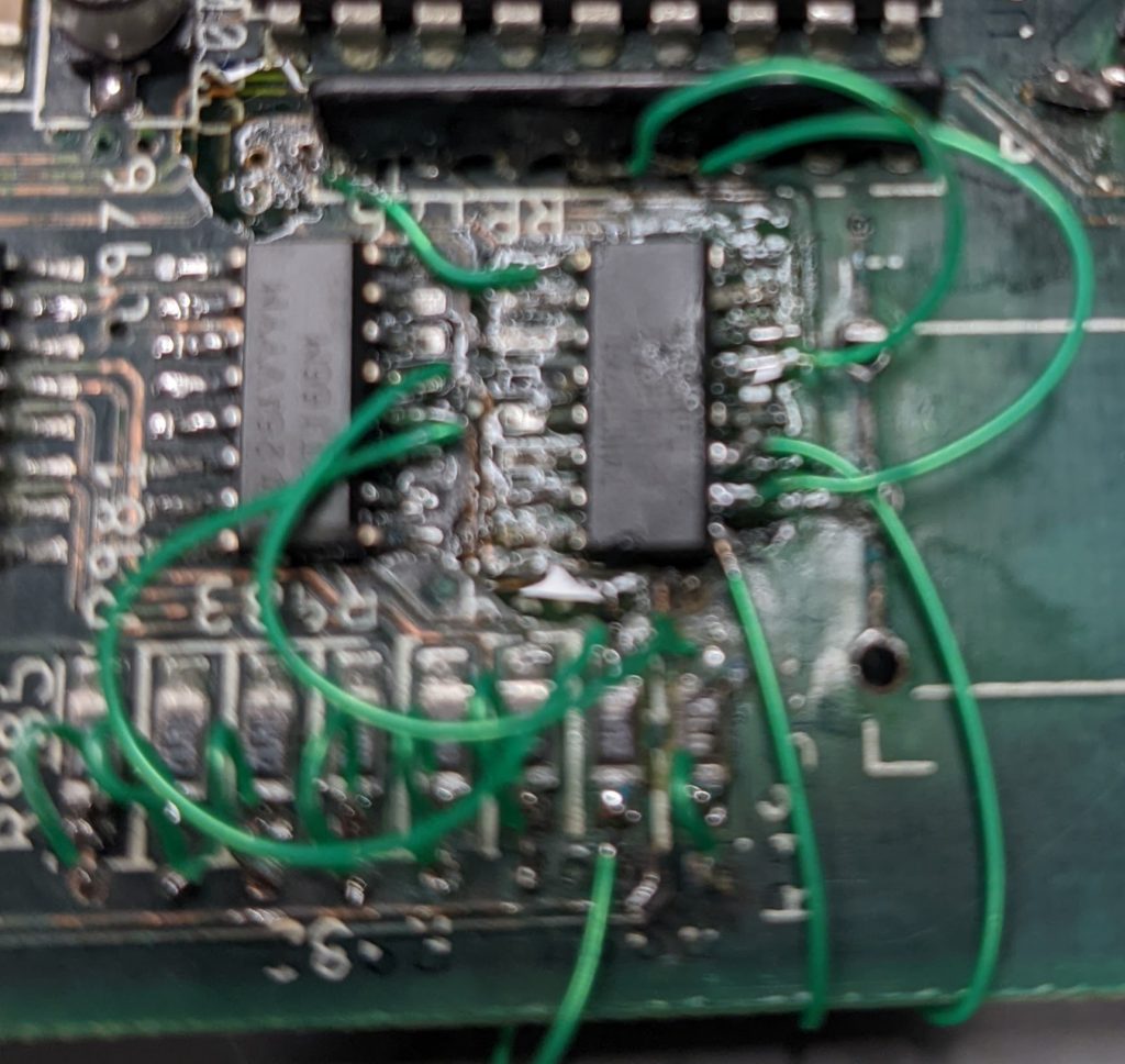 A blurry picture of a hot mess of bodge wiring around U177 on a Commodore Amiga 4000 motherboard