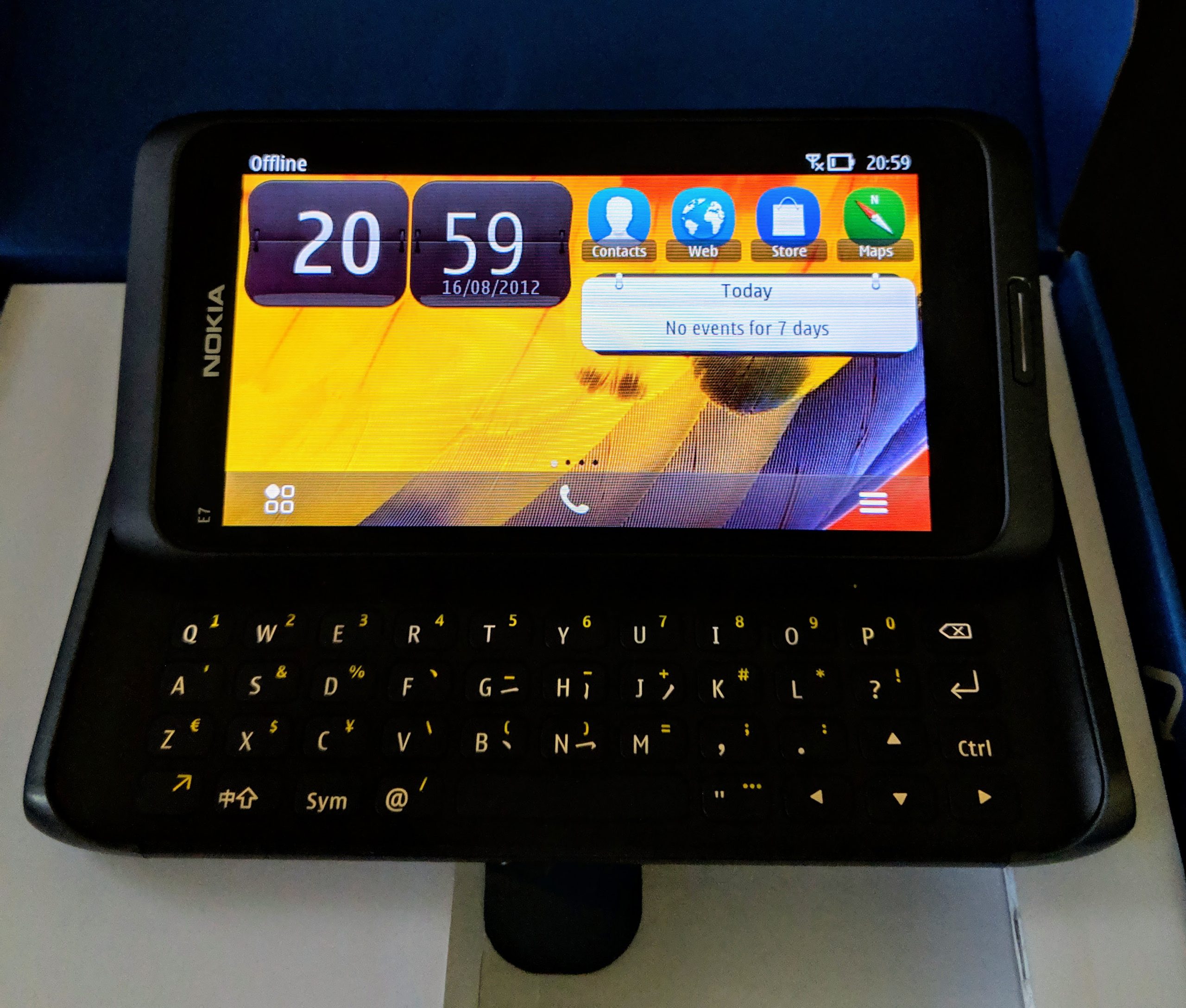 Nokia E7 in landscape orientation, keyboard out, and powered on